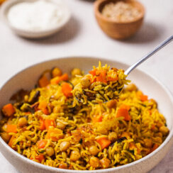 Curried rice and roasted vegetables in a serving dish