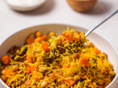 Curried rice and roasted vegetables in a serving dish