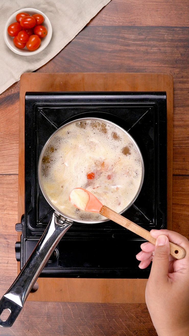 Lentils, stock, and coconut milk simmering in a pot to make South Indian dal.