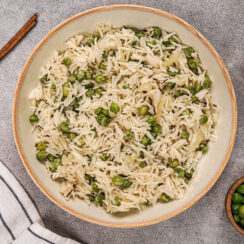 Pea pulao recipe resting in a bowl in the kitchen.