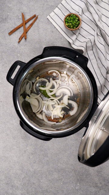 Onions sizzle in an Instant Pot.