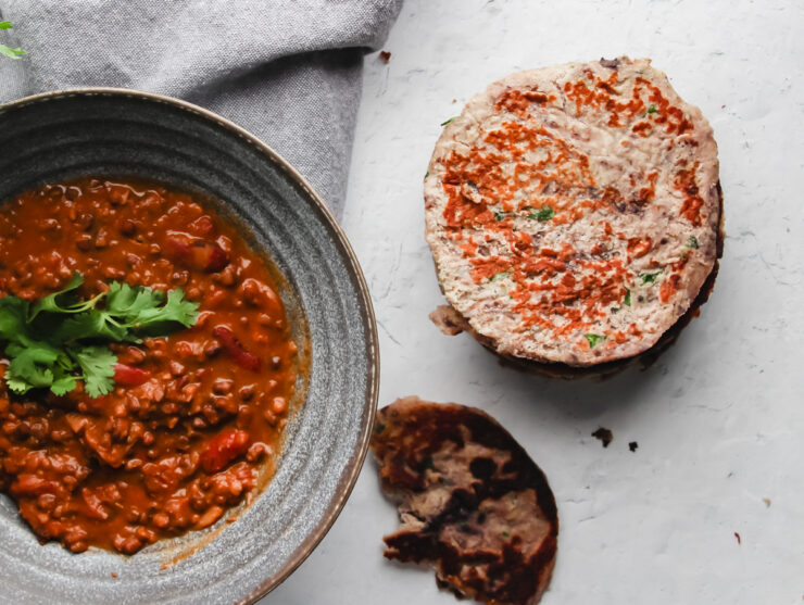 Delicious round keto flatbreads served alongside a red Indian curry.