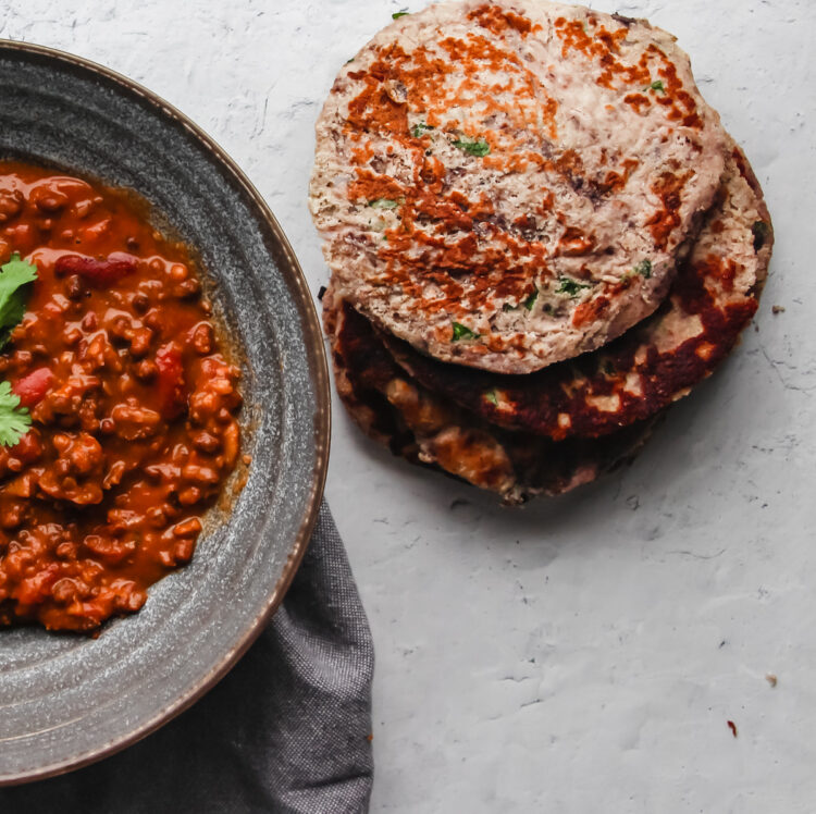 Keto flatbread pieces piled together and served alongside a warming red curry.