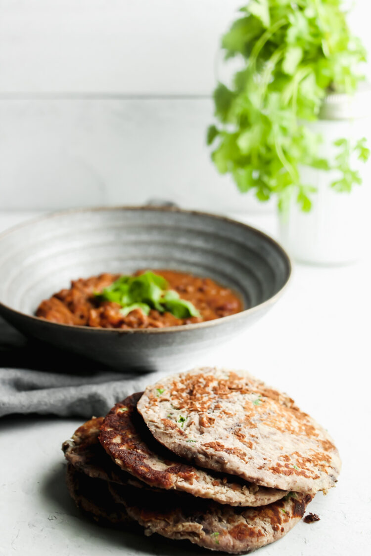 Delicious, round keto flatbread pieces served alongside a bowl of red curry.

