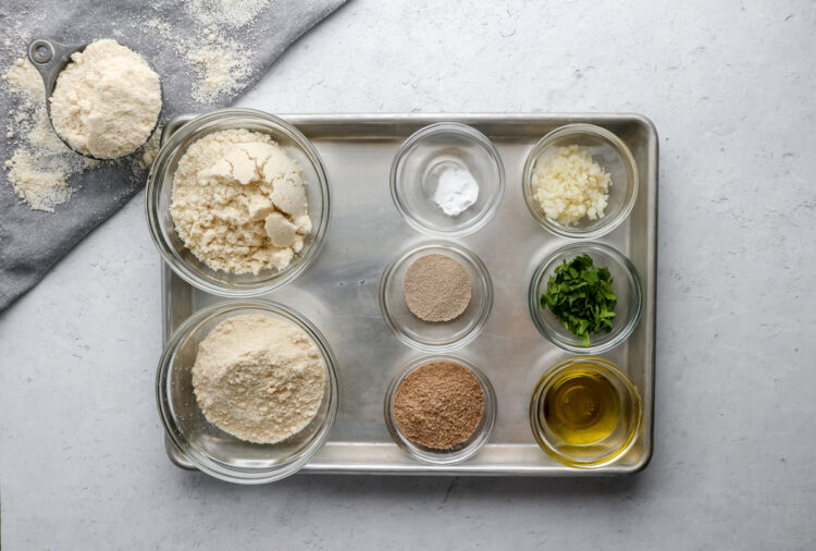 Ingredients for a keto flatbread recipe, including coconut flour, almond flour, olive oil, cilantro and psyllium husk.