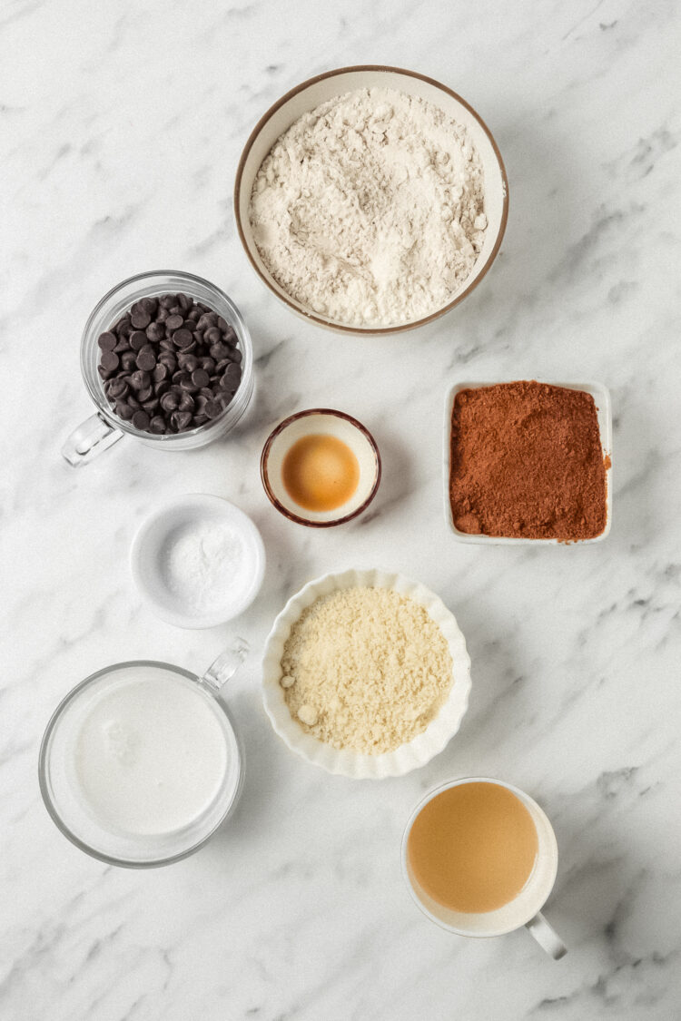 Picture of the ingredients in bowls and measuring cups for egg-free chocolate chip cookies.
