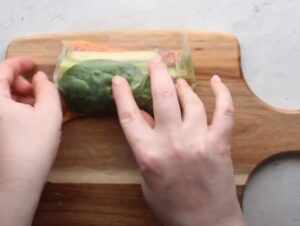 Vegan spring rolls being made by hand