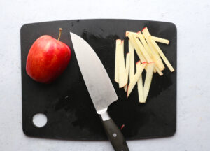 Sliced apples on a cutting board being prepared to make Vegan Vietnamese Spring Rolls