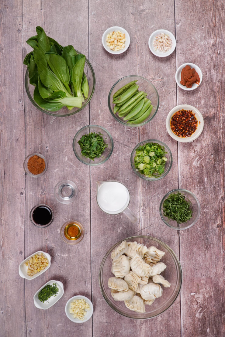 Ingredients for the dumpling bake recipe, including bok choy, snap peas and vegetable dumplings.